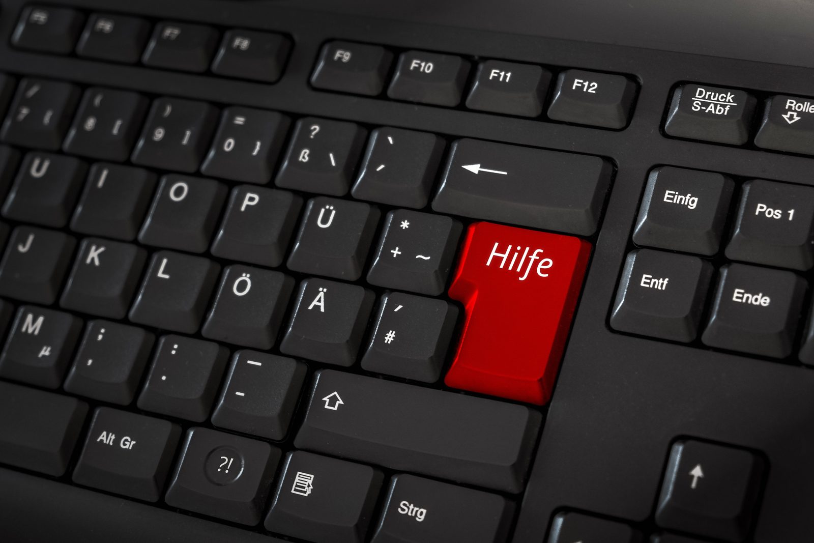 Eine Tastatur mit einer roten Taste, auf der Hilfe steht
