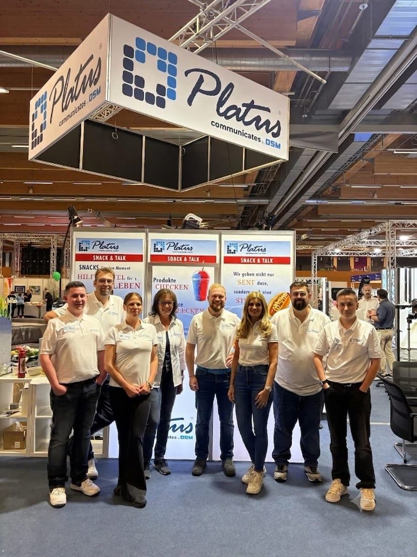Das Platus-Team am Messestand im Gespraech mit Besuchern